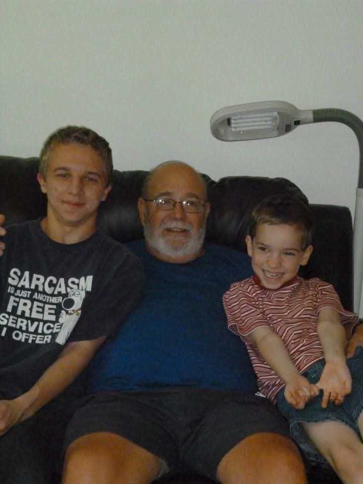 On the couch with kids, smiling
