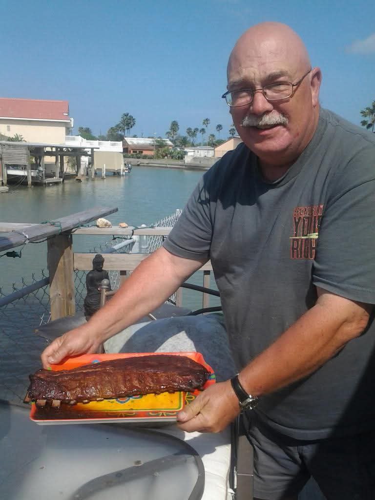Holding a rack of ribs by the water
